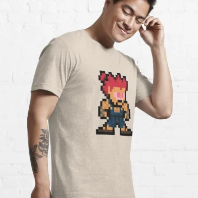 Homme qui porte un tee-shirt beige Street Fighter avec le personnage Akuma en pixels rouge et bleu