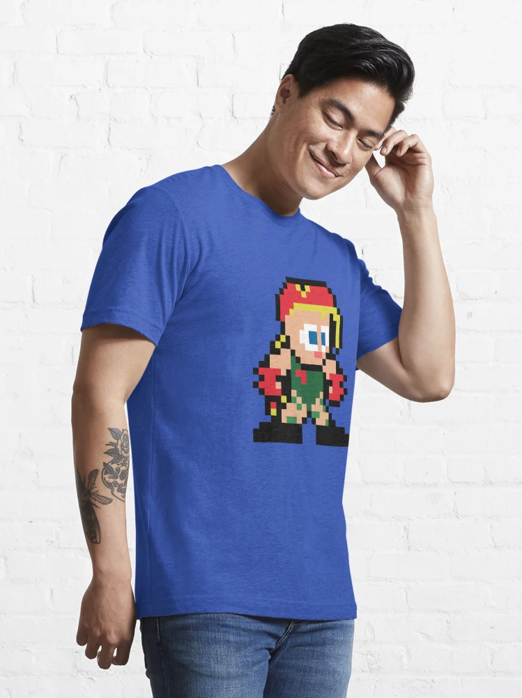 Homme qui porte un tee-shirt bleu électrique Street Fighter avec le personnage Cammy en pixels rouge et jaune